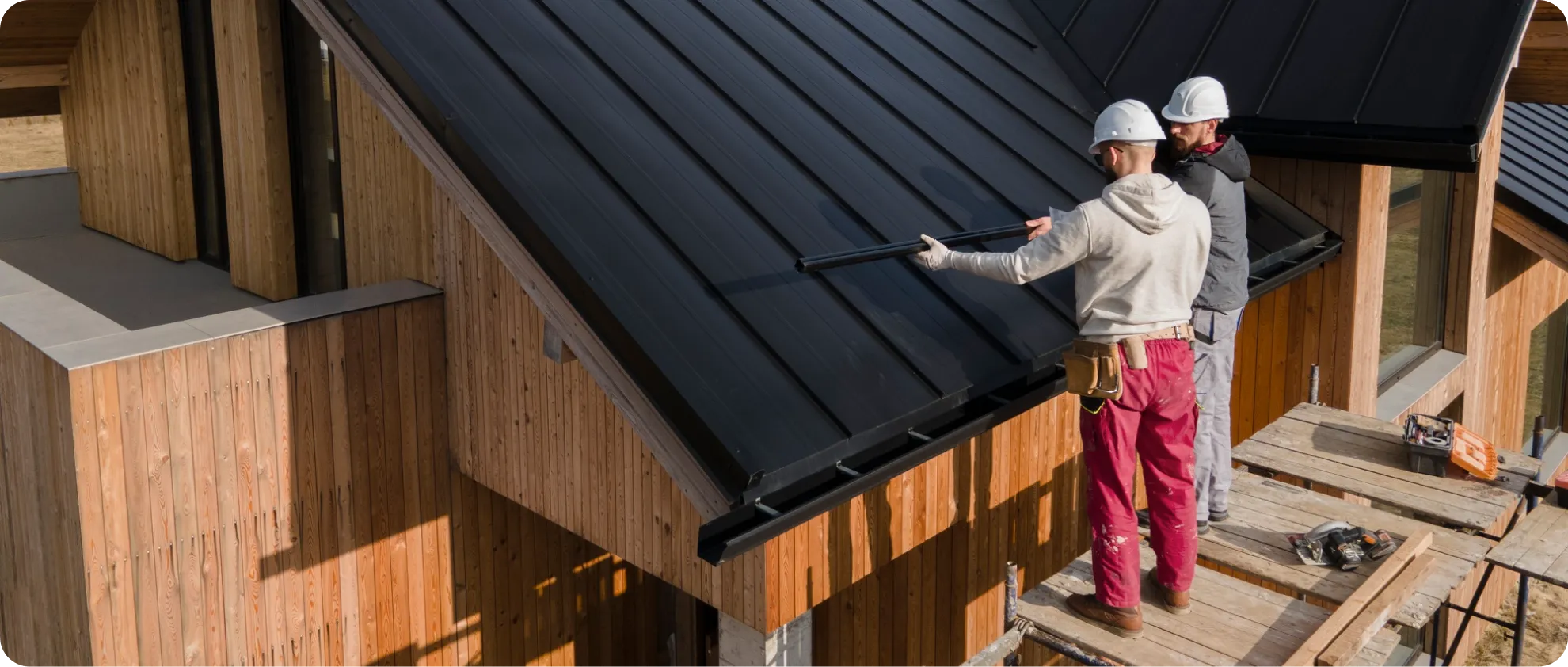 Roofer installing shingles on a sloped roof